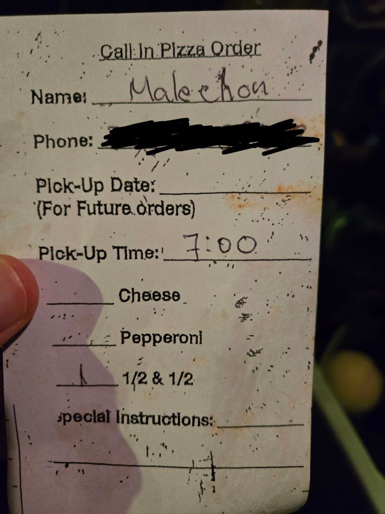 A handwritten receipt for a Costco pizza phone-in order, with "Malechon" written at the top