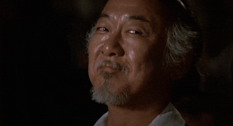 Mr. Miyagi from "The Karate Kid" looking at his student with pride