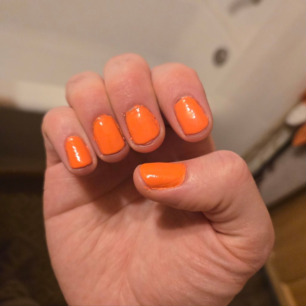 The author's right hand, showing off his neon orange nail polish